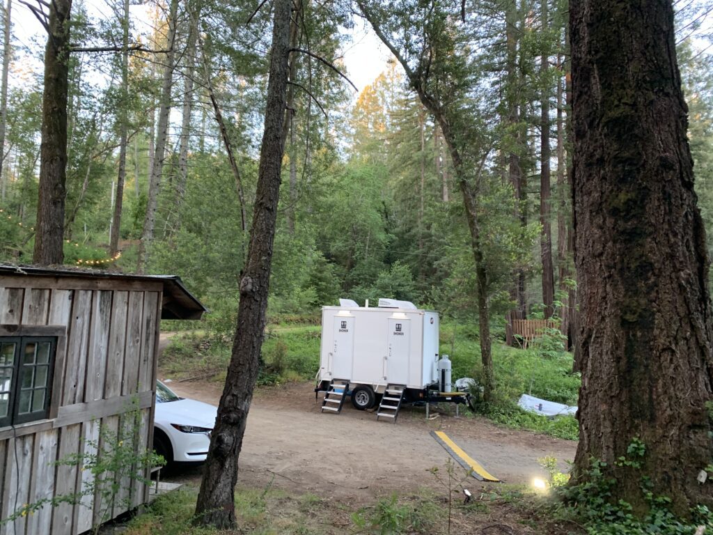 The Lavatory Utah 2 Stall Shower Trailer in Woods Glamping - Outdoor View